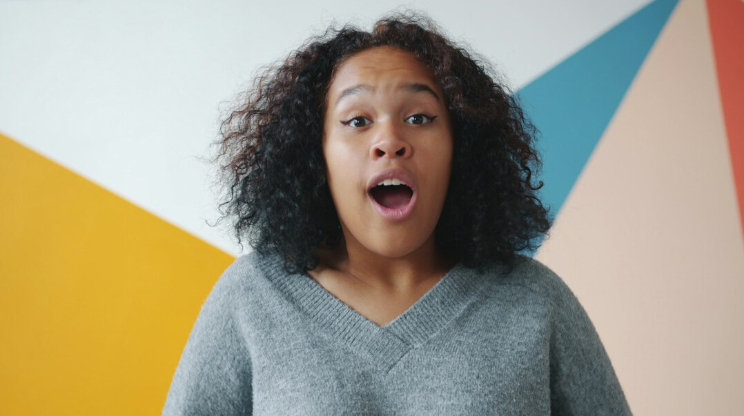 Smiling Brazilian woman gesturing positively while talking